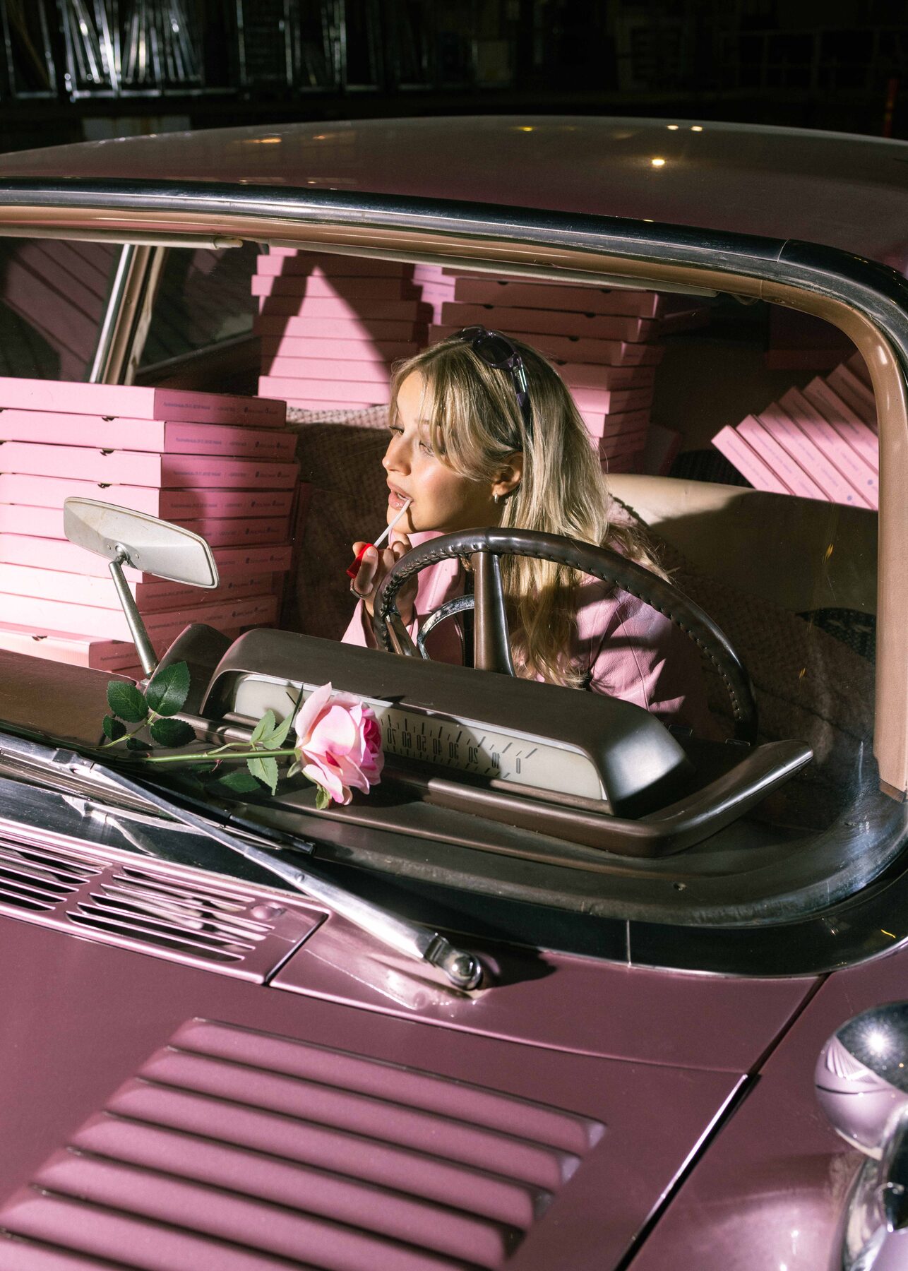 Forza — Pizzacar campaign: pink Mercedes loaded with pizza boxes, a single rose on the dashboard, night exterior.